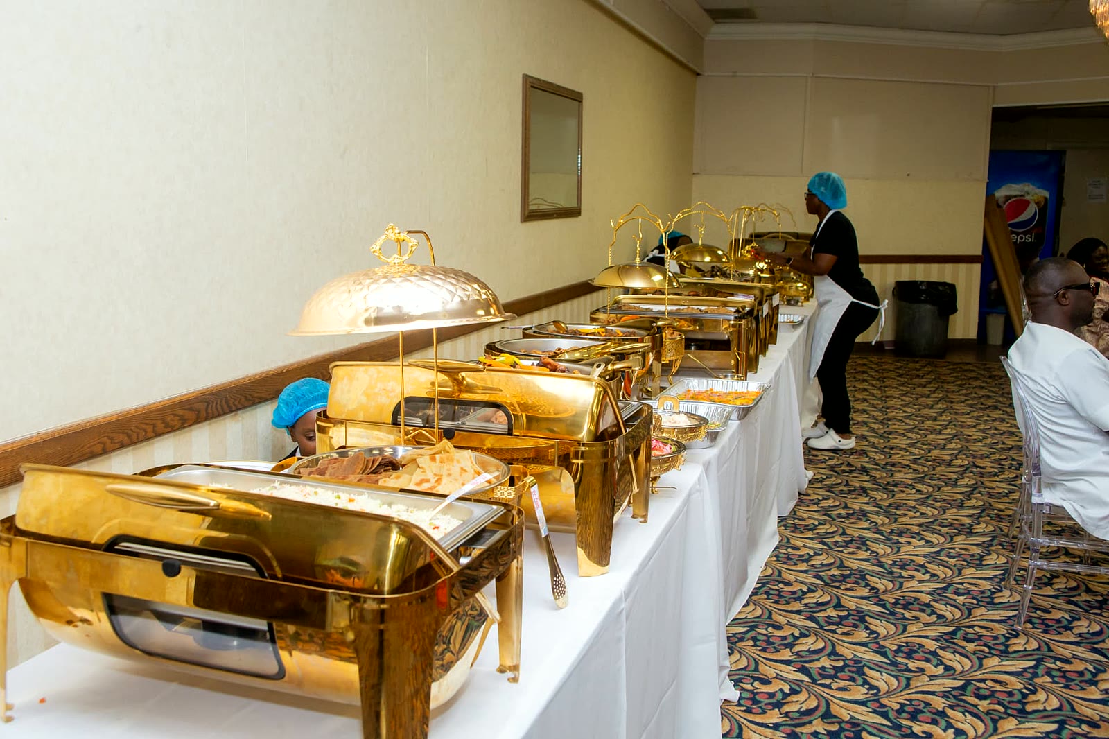 Full gold chafing dish buffet setup along a white-linen table in a Toronto banquet hall